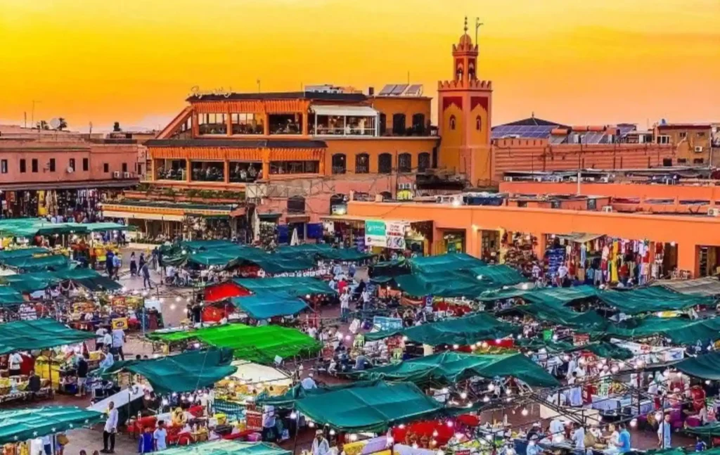 A vibrant sunset view over the bustling Jemaa el-Fnaa square in Marrakech, a must-see destination on a 10 days Morocco itinerary.