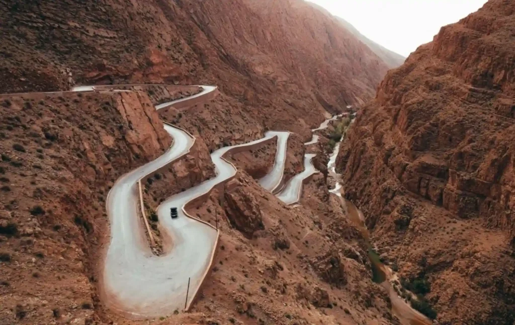 A breathtaking aerial view of the winding Tisdrine Road in Dades Gorge, a highlight of our 12 days in Morocco tour.