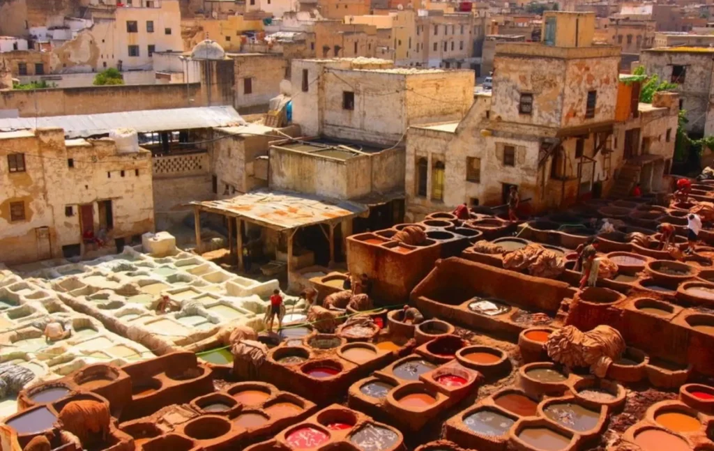 This image captures the legendary Chouara Tannery in Fez, Morocco—a site that has remained virtually unchanged since the 11th century. As the largest and oldest tannery in the city, it is a centerpiece of any Morocco itinerary 8 days