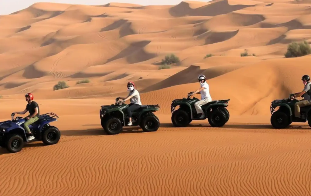 Travelers on a Merzouga quad 1 hour tour across dunes with Merzouga desert tours.