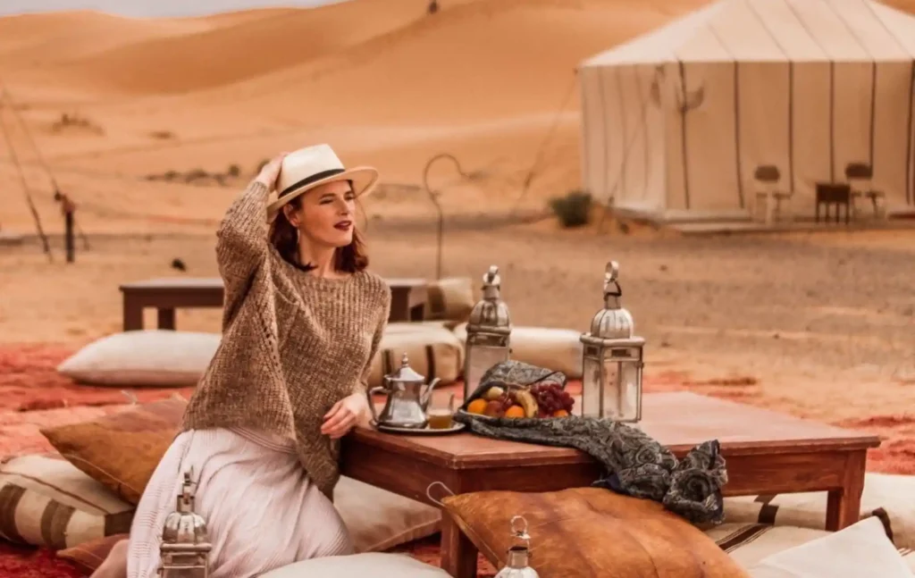 A traveler enjoying tea at a luxury camp during a 4 day desert tour from Marrakech to fes.