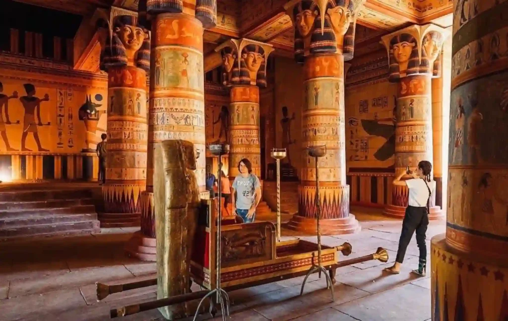 Travelers exploring an Egyptian-style movie set at the famous Atlas Film Studios in Ouarzazate during a 4 days tour from Fes to Marrakech.