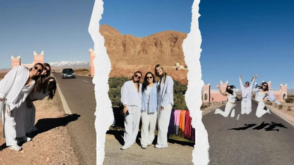 Three friends posing and jumping on the scenic road through the Atlas Mountains during a shared marrakech to fes desert tour 3 days.
