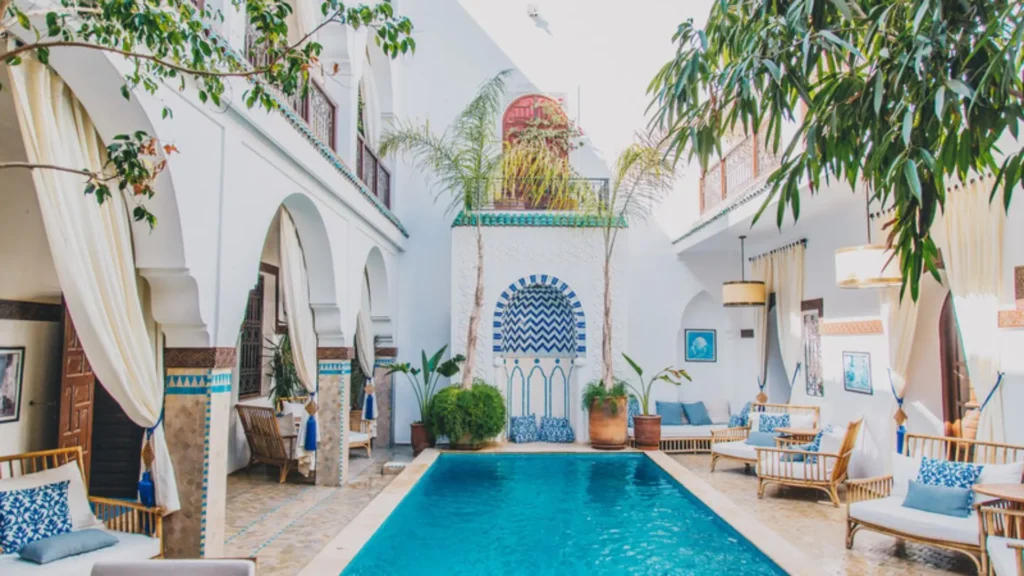 Things to do in Marrakech experiencing a traditional luxury hammam spa with a beautiful indoor pool and blue zellij tiles