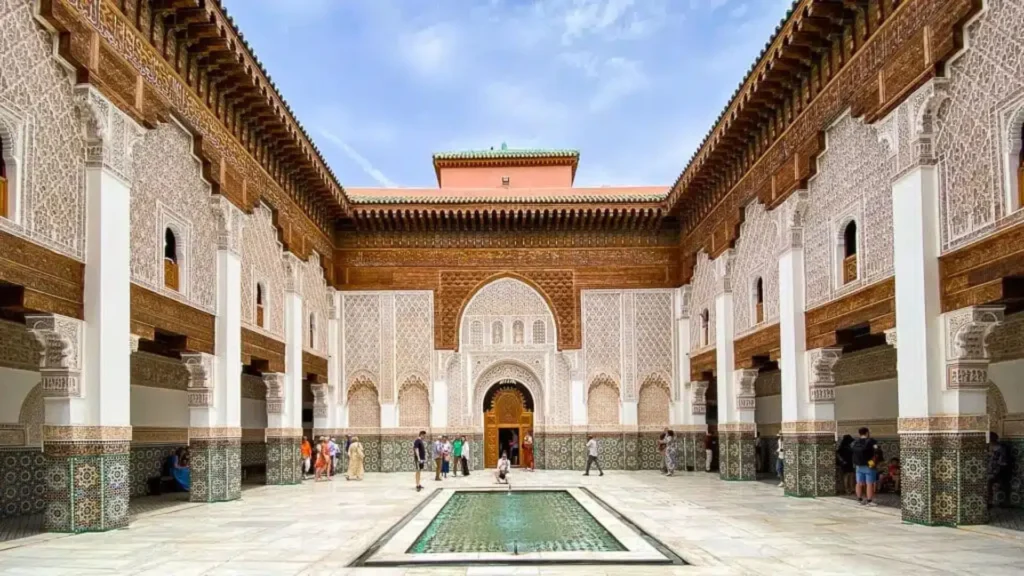 Things to do in Marrakech visiting the grand courtyard and carved stucco of Ben Youssef Medersa