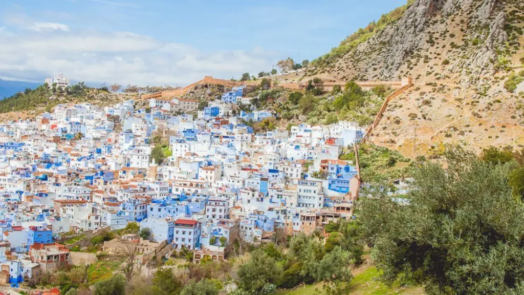 A wide panoramic view of the blue city Chefchaouen, a popular northern stop included in Casablanca desert tours and a complete morocco itinerary.