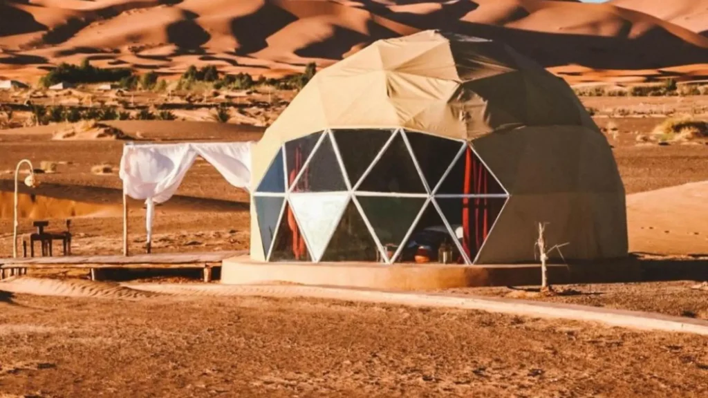 Best way to travel from Portugal to Morocco booking a luxury desert tour with geodesic dome glamping tents in Merzouga