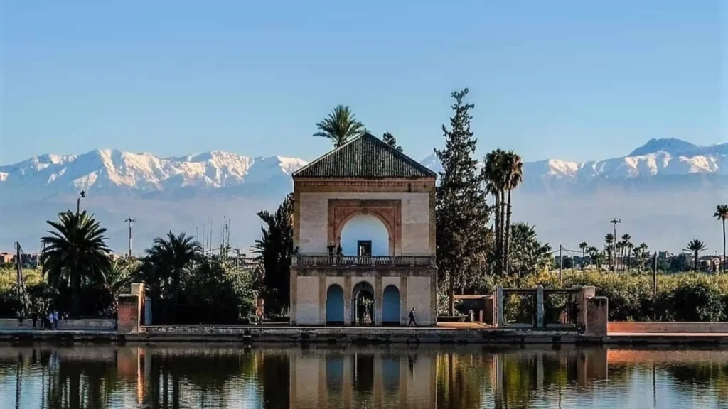 Best way to travel from Portugal to Morocco flying to Marrakech to visit the historic Menara Gardens pavilion and reflection pool