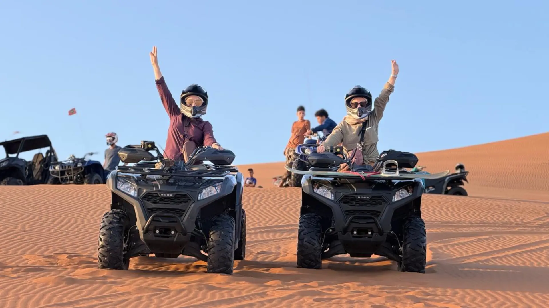 Two travelers on quad bikes on the Sahara dunes
