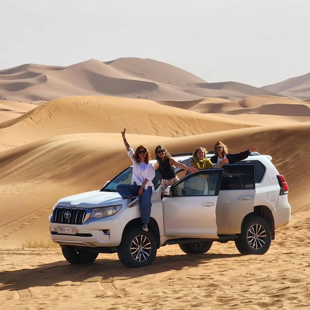 Travelers on a Toyota Land Cruiser in the Erg Chebbi dunes