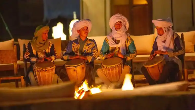 Students tours to Morocco: Berber musicians playing drums around the fire at the Sahara desert camp at night